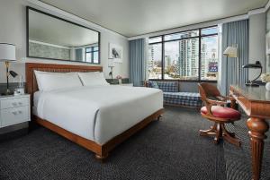 a bedroom with a large bed and a large window at Pendry San Diego in San Diego