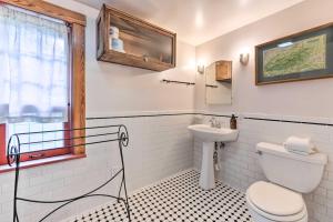 a bathroom with a toilet and a sink at Cozy Mama Bear Cabin with Mountain Views! in Clyde