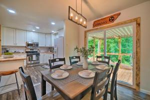 a kitchen and dining room with a table and chairs at Updated Knoxville Home with Media Room and Patio! in Knoxville