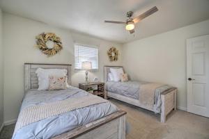 a bedroom with two beds and a ceiling fan at Updated Knoxville Home with Media Room and Patio! in Knoxville