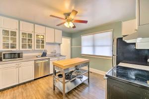 a kitchen with white cabinets and a ceiling fan at Central Salt Lake City Haven Less Than 5 Mi to Dtwn! in Salt Lake City