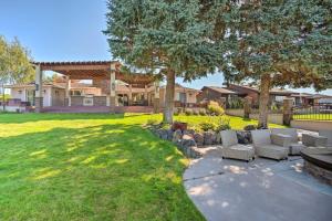 a yard with two couches and trees and a house at Moses Lake Retreat with Salt Water Hot Tub! in Moses Lake