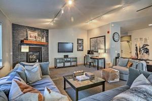 a living room with a couch and a table at Modern Frisco Condo with Deck Walk to Main St! in Frisco