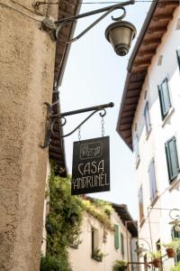 a sign hanging on the side of a building at Casa L'Andrunèl in Limone sul Garda