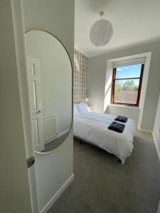 a bedroom with a large mirror and a bed at The Haven in Greenock