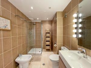 a bathroom with a toilet and a sink and a shower at Marbella del Mar II Beachfront- EaW Homes in Marbella +27 photos