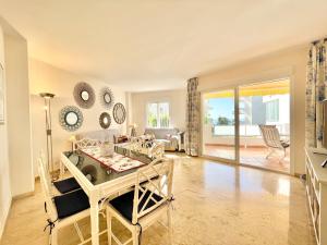 a living room with a table and a dining room at Marbella del Mar II Beachfront- EaW Homes in Marbella