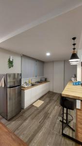 a kitchen with a stainless steel refrigerator and a table at Vivacity Apartment Jazz 1 54 in Kuching