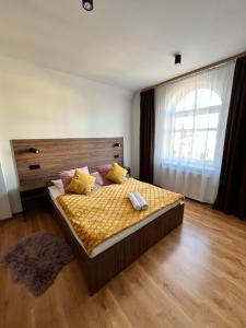 a bedroom with a bed and a large window at Hotel i Restauracja „KRISTAL” in Braniewo