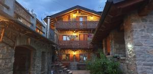 ein Gebäude mit einem Balkon mit Beleuchtung in der Unterkunft SUITE DEL VILLAGGIO in Aosta