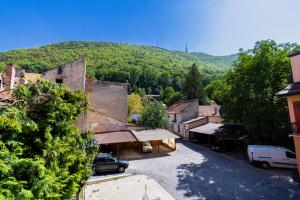 a view of a village with a mountain in the background at Black Gate - Quiet Studio in the Heart of Old Town with Free Private Secured Parking in Braşov