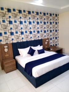 A bed or beds in a room at Proxima Centauri Hotel