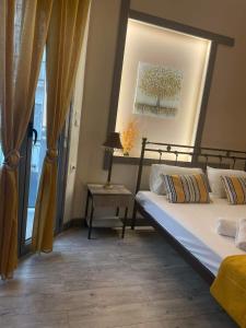 a bedroom with a bed and a table with a lamp at MATEO in Livadeia