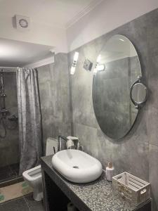 a bathroom with a sink and a mirror at MATEO in Levádeia