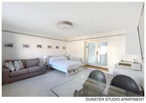 a living room with a bed and a couch at Dunster Studio Apartment in Dunster