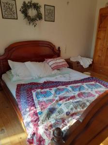 a bed with a quilt on it in a bedroom at CRETAN ROOTS HOME in Kokkíni Khánion