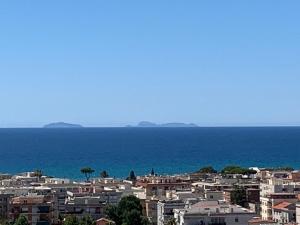 a city with houses and the ocean in the background at Minerva Lodge - Panoramico centro storico Terracina in Terracina