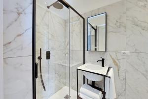a bathroom with a glass shower and a sink at Youroom - Coppelle in Rome