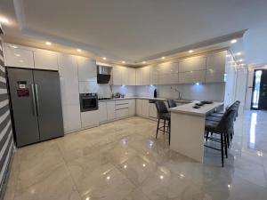 a kitchen with white cabinets and a table and chairs at Beachside Villa in Silivri
