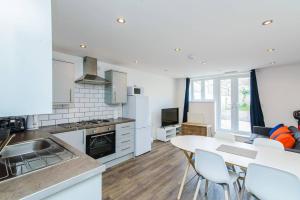 a kitchen and living room with a table and chairs at 4 Freeland Buildings in Bristol