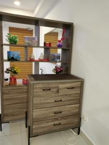 a wooden dresser in a room with a shelf at Happy Home@Teega Residence Puteri Harbour in Nusajaya