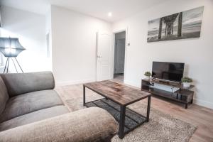 a living room with a couch and a coffee table at 62b Mina Rd in Bristol