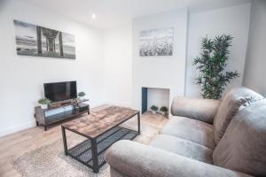 a living room with a couch and a table at 62b Mina Rd in Bristol