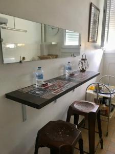 a kitchen counter with two bottles of water on it at Esprit Cosy in Alençon