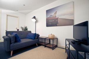 a living room with a couch and a flat screen tv at 56a Mina Rd in Bristol