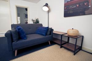 a living room with a blue couch and a table at 56a Mina Rd in Bristol
