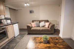 a living room with a couch with pillows on it at Flat 1, 4 Warden Rd in Bristol