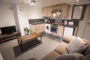 a kitchen with a couch and a table in a room at Flat 1, 4 Warden Rd in Bristol
