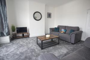 a living room with a couch and a coffee table at 20b Ralph rd in Bristol