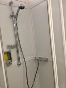 a shower with a shower head in a bathroom at Esprit Cosy in Alençon