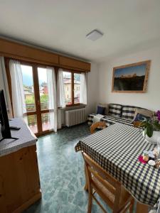 a living room with a table and a couch at Dolomitihouse AUNER in Fiera di Primiero