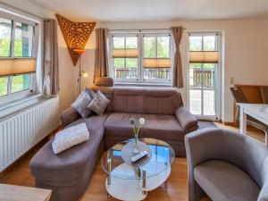 a living room with a couch and a table at Ferienanlage Zum Wildbach Schierke in Schierke