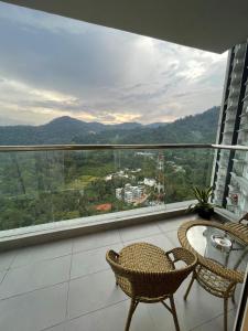 a balcony with a table and chairs and a view at Kincir Homesuites - Free WiFi & Netflix in Genting Highlands