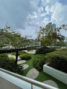 a park with a tree and walkways and bushes at Kincir Homesuites - Free WiFi & Netflix in Genting Highlands