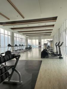 a gym with rows of treadmills and exercise bikes at Kincir Homesuites - Free WiFi & Netflix in Genting Highlands