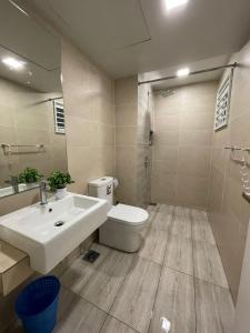 a bathroom with a sink and a toilet and a shower at Kincir Homesuites - Free WiFi & Netflix in Genting Highlands