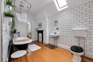 a white bathroom with a sink and a toilet at Luxury 2 bed apartment in the heart of Chester in Chester