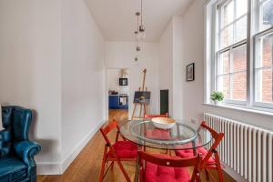 a dining room with a glass table and two chairs at Luxury 2 bed apartment in the heart of Chester in Chester