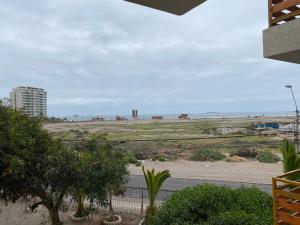a view of the beach from the balcony of a house at Departamento Vistamar 4 puertas del pacifico in Arica