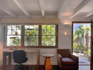 a room with two chairs and a table and windows at Casa Del Mar Inn in Santa Barbara