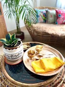 a table with a plate of food and a plant at Bhuman Homestay in Siliguri