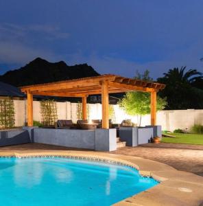 a pergola and a swimming pool in a yard at Sunnyside of Life Retreat: Serene 5 BR with pool in Phoenix