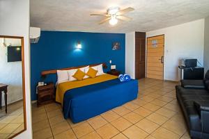 - une chambre bleue avec un lit et un canapé dans l'établissement Lorencillo Miramar, à Tampico