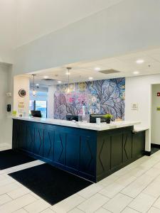a lobby with a blue counter and a colorful wall at La Quinta by Wyndham Mt. Laurel - Philadelphia in Mount Laurel