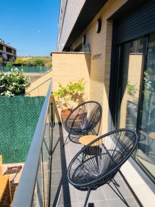 een balkon met 2 stoelen en een tafel. bij La Puerta de Viana, con desayuno, piscina y posibilidad Visita a bodega! in Viana