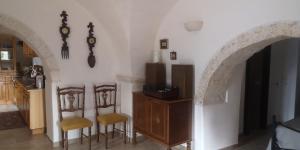 a kitchen with two chairs and a table with a tv at Cummersa dell'alba in Locorotondo